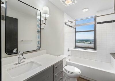 Bathroom with White Tile Walls in Merchant's Plaza Apartment
