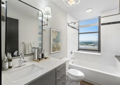 Bathroom with White Tile Walls in Merchant's Plaza Apartment